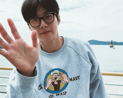 A Man Wearing A Sweatshirt That Says Uss Wasp GIF