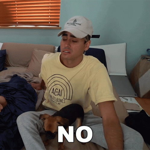 A Man Wearing A T-Shirt That Says Acai World 'S Bowls Sits On A Bed With His Dog GIF