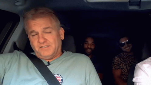A Man Wearing A T-Shirt That Says ' American ' On It GIF