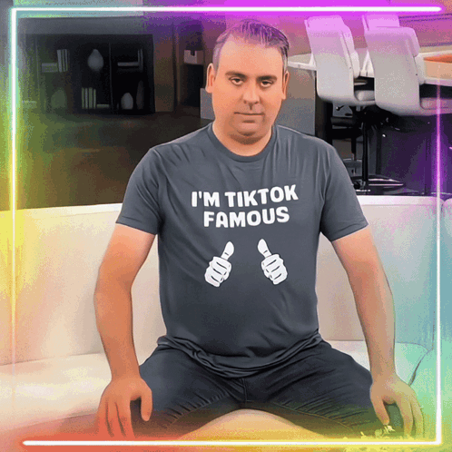 A Man Wearing A T-Shirt That Says " I 'M Tiktok Famous " GIF