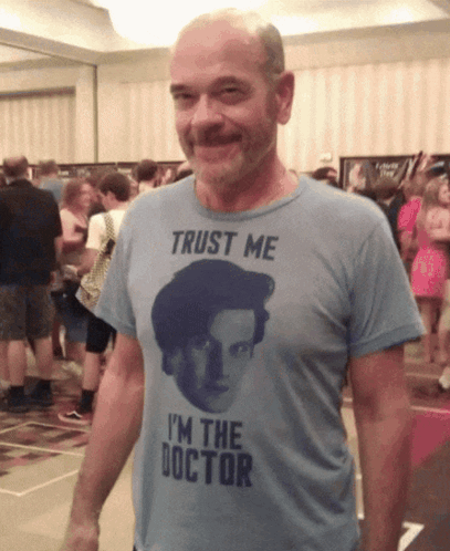 A Man Wearing A T-Shirt That Says " Trust Me I 'M The Doctor " GIF