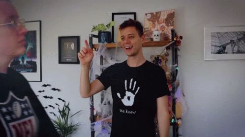 A Man Wearing A T-Shirt That Says We Know GIF