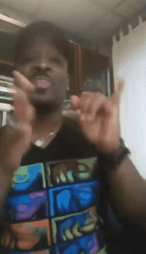 A Man Wearing A T-Shirt With The Word Face On It Is Giving A Peace Sign GIF