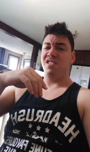 A Man Wearing A Tank Top That Says H2u9a3h Makes A Funny Face GIF