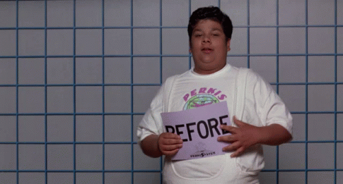 A Man Wearing A Tank Top That Says Pernis Is Holding A Camera GIF
