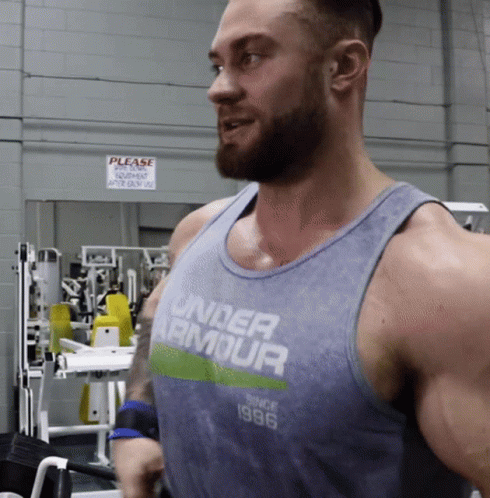 A Man Wearing A Tank Top That Says Under Armour On It GIF