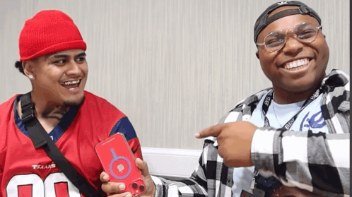 A Man Wearing A Texans Jersey Holds A Red Phone Case GIF