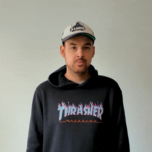 A Man Wearing A Thrasher Hoodie And A Hat GIF