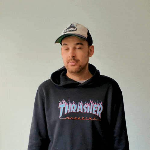 A Man Wearing A Thrasher Magazine Hoodie And A Hat GIF