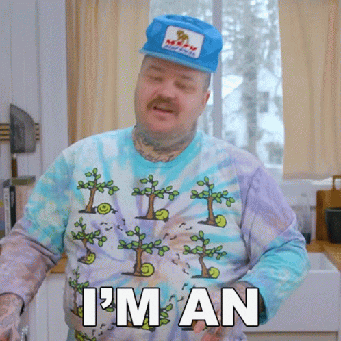 A Man Wearing A Tie Dye Shirt And A Hat Says " I 'M An " GIF