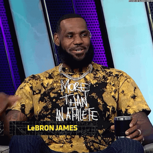A Man Wearing A Tie Dye T-Shirt That Says More Than An Athlete GIF