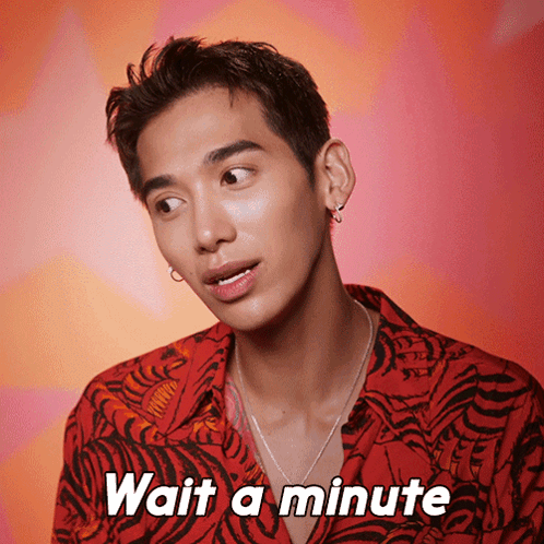 A Man Wearing A Tiger Print Shirt Says " Wait A Minute " GIF