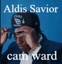 A Man Wearing A Titans Hat With The Name Aldis Savior Cam Ward On The Bottom GIF