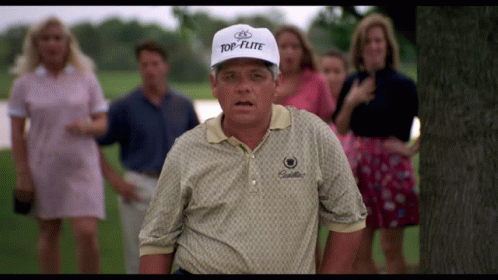 A Man Wearing A Top-Flite Hat Stands In Front Of A Group Of People GIF