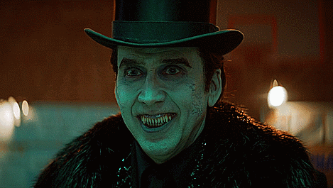 A Man Wearing A Top Hat And A Fur Coat Has Sharp Teeth GIF