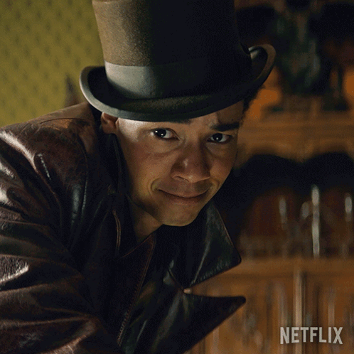 A Man Wearing A Top Hat And A Leather Jacket With A Netflix Logo In The Corner GIF