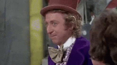 A Man Wearing A Top Hat And A Purple Suit Is Looking At Another Man . GIF