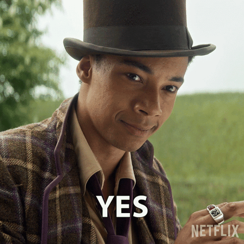 A Man Wearing A Top Hat And A Purple Tie Says Yes GIF