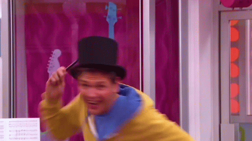 A Man Wearing A Top Hat And A Yellow Jacket GIF