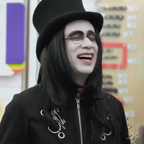 A Man Wearing A Top Hat And Glasses Laughs GIF