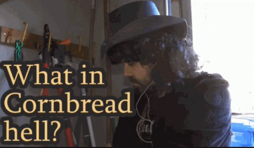 A Man Wearing A Top Hat With The Words What In Cornbread Hell Written Above Him GIF