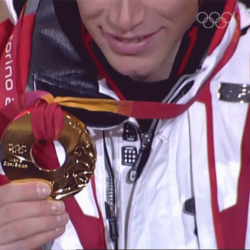 A Man Wearing A Torino Jacket Is Holding A Medal GIF
