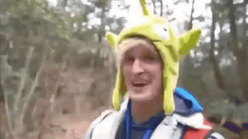 A Man Wearing A Toy Story Alien Hat And A Life Jacket . GIF