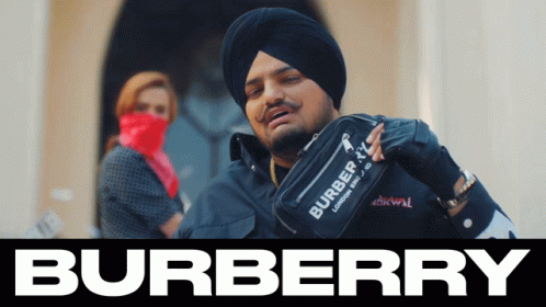 A Man Wearing A Turban Holds A Burberry Bag GIF