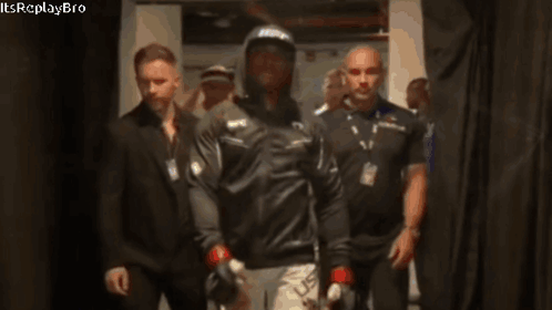 A Man Wearing A Ufc Hat Walks Through A Hallway GIF