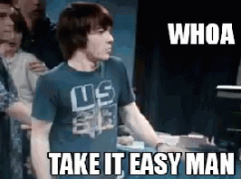 A Man Wearing A Us Shirt Is Standing In Front Of A Crowd And Says Whoa Take It Easy Man . GIF