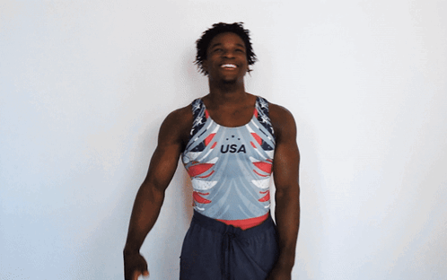A Man Wearing A Usa Tank Top Is Smiling GIF