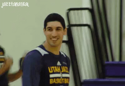 A Man Wearing A Utah Jazz Basketball Shirt Smiles GIF