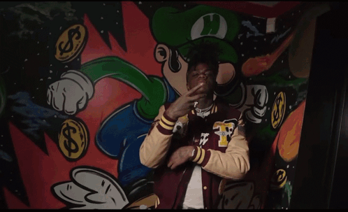 A Man Wearing A Varsity Jacket With The Letter F On The Sleeve GIF