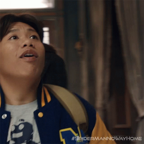 A Man Wearing A Varsity Jacket With The Letter M On The Front GIF