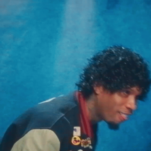 A Man Wearing A Varsity Jacket With The Letter R On The Front GIF