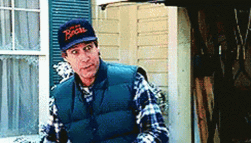 A Man Wearing A Vest And A Hat With The Word Bacon Written On It GIF