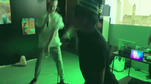 A Man Wearing A Virtual Reality Headset Is Dancing In A Room GIF