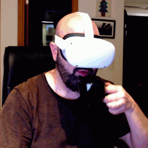 A Man Wearing A Virtual Reality Headset With A Christmas Tree In The Background GIF