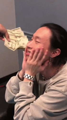 A Man Wearing A Watch Is Being Handed A Stack Of Money GIF