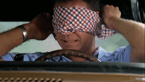 A Man Wearing A Watch Is Blindfolded While Driving GIF