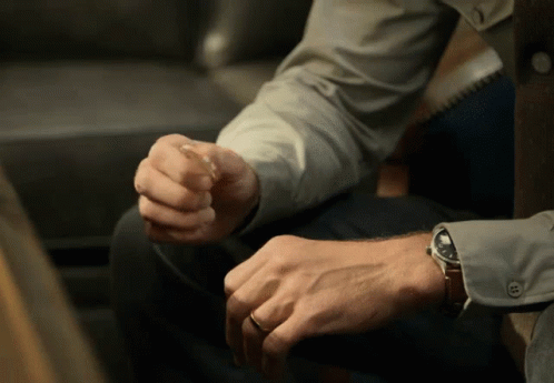 A Man Wearing A Watch Is Sitting Down GIF