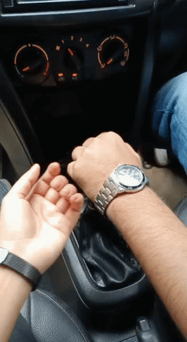 A Man Wearing A Watch Is Sitting In A Car With A Woman GIF