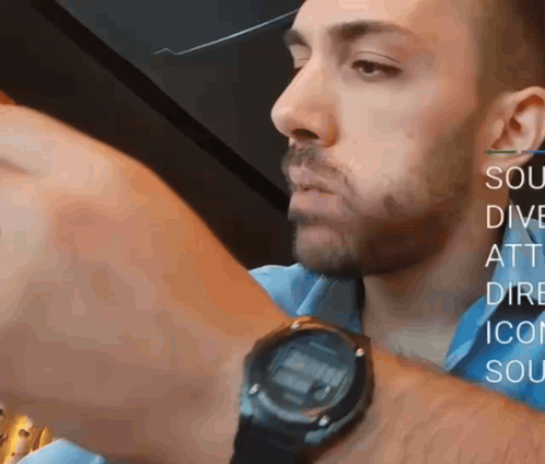 A Man Wearing A Watch With The Words Sou Dive Att Dire Icon Soc On The Bottom GIF