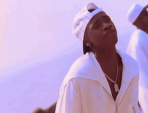 A Man Wearing A White Baseball Cap And A White Shirt GIF
