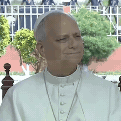 A Man Wearing A White Collared Shirt And A White Hat GIF