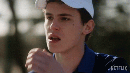A Man Wearing A White Hat And A Blue Shirt With Netflix Written On The Bottom GIF