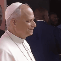 A Man Wearing A White Hat And Collared Shirt GIF