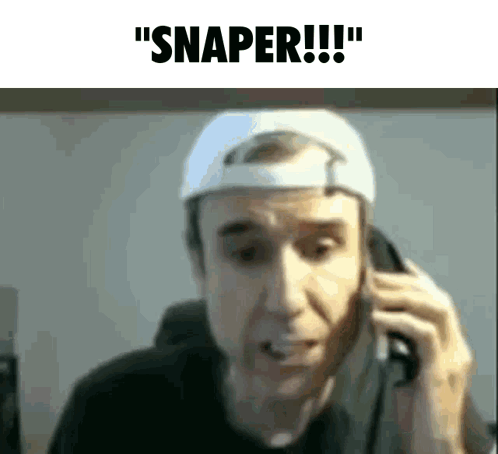 A Man Wearing A White Hat Is Talking On A Cell Phone And Says Snaper GIF