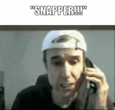 A Man Wearing A White Hat Is Talking On A Cell Phone And Says Snapper GIF