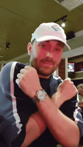 A Man Wearing A White Hat That Says ' Bud Light ' On It GIF